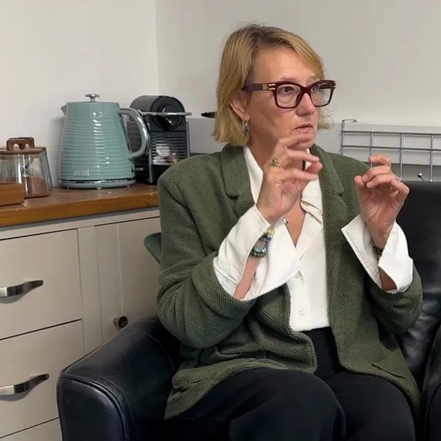 Gayle in conversation with a client at the GS Associates office